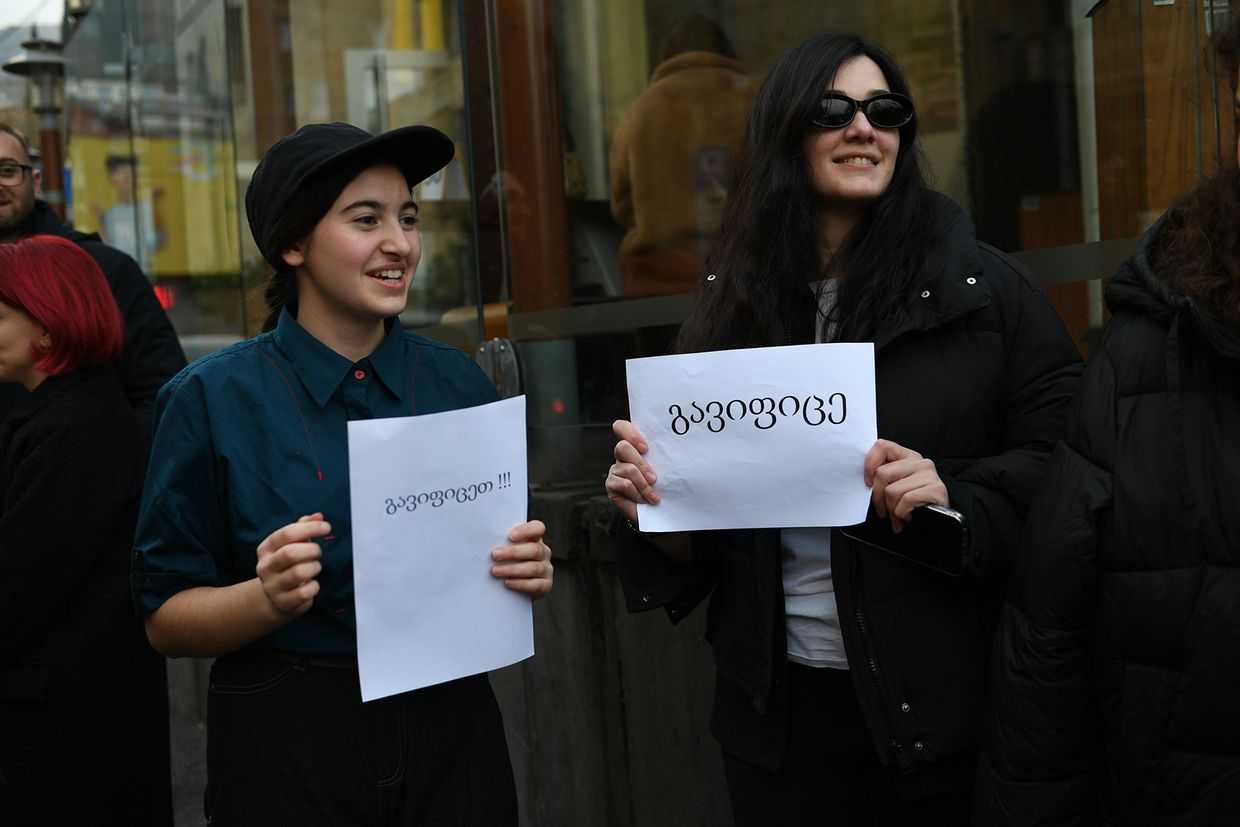 McDonald’s employees on Rustaveli Avenue hold paper with the word ‘Strike’ outside a closed branch of the franchise on Rustaveli Avenue on 15 January 2025. Photo: Mariam Nikuradze/OC Media.