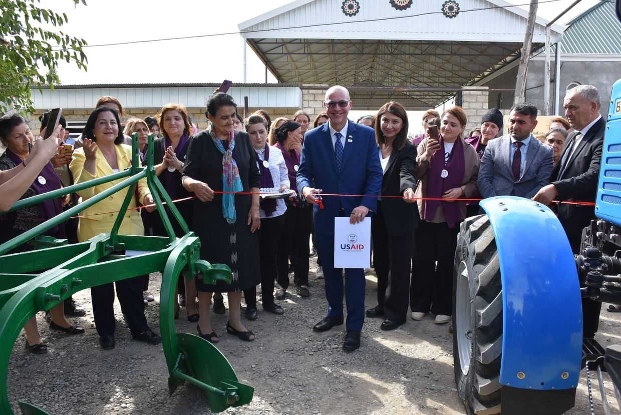 USAID Azerbaijan director Michael Nehrbass opening an agro-industrial centre established by ten women from the village of Boluslu . Official image.