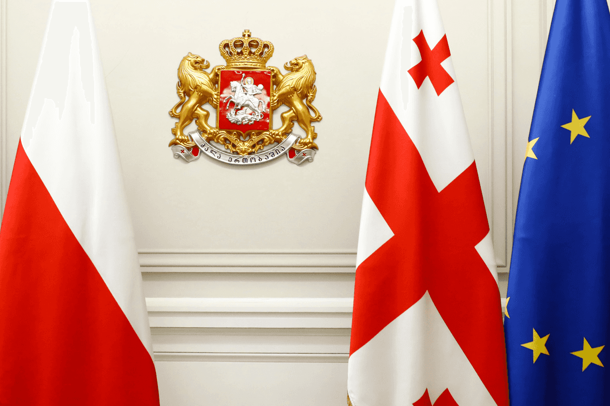 The flags of Poland (far left), Georgia (right), and the EU (far right). Photo via Wikimedia Commons.