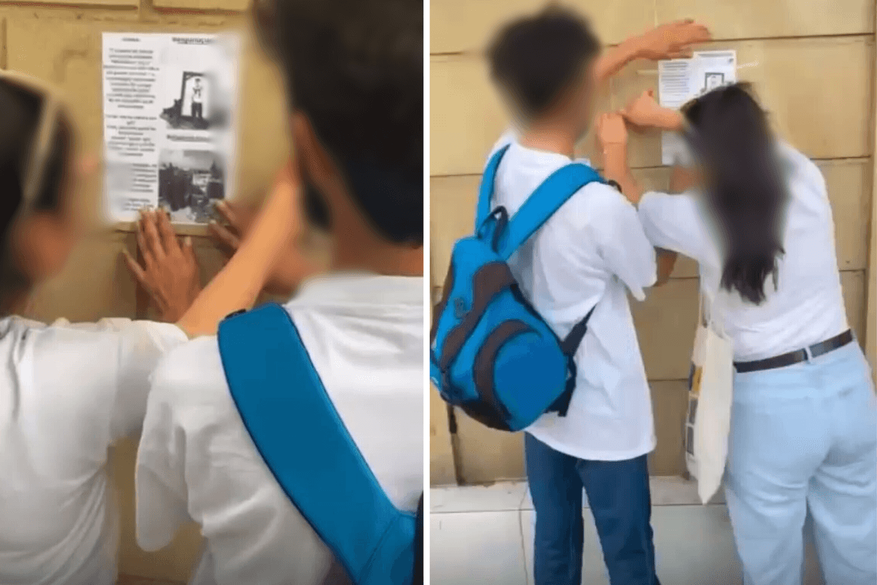 Teenagers stick pamphlets to walls in the Gazakh district. Screenshot from a video shared via social media.