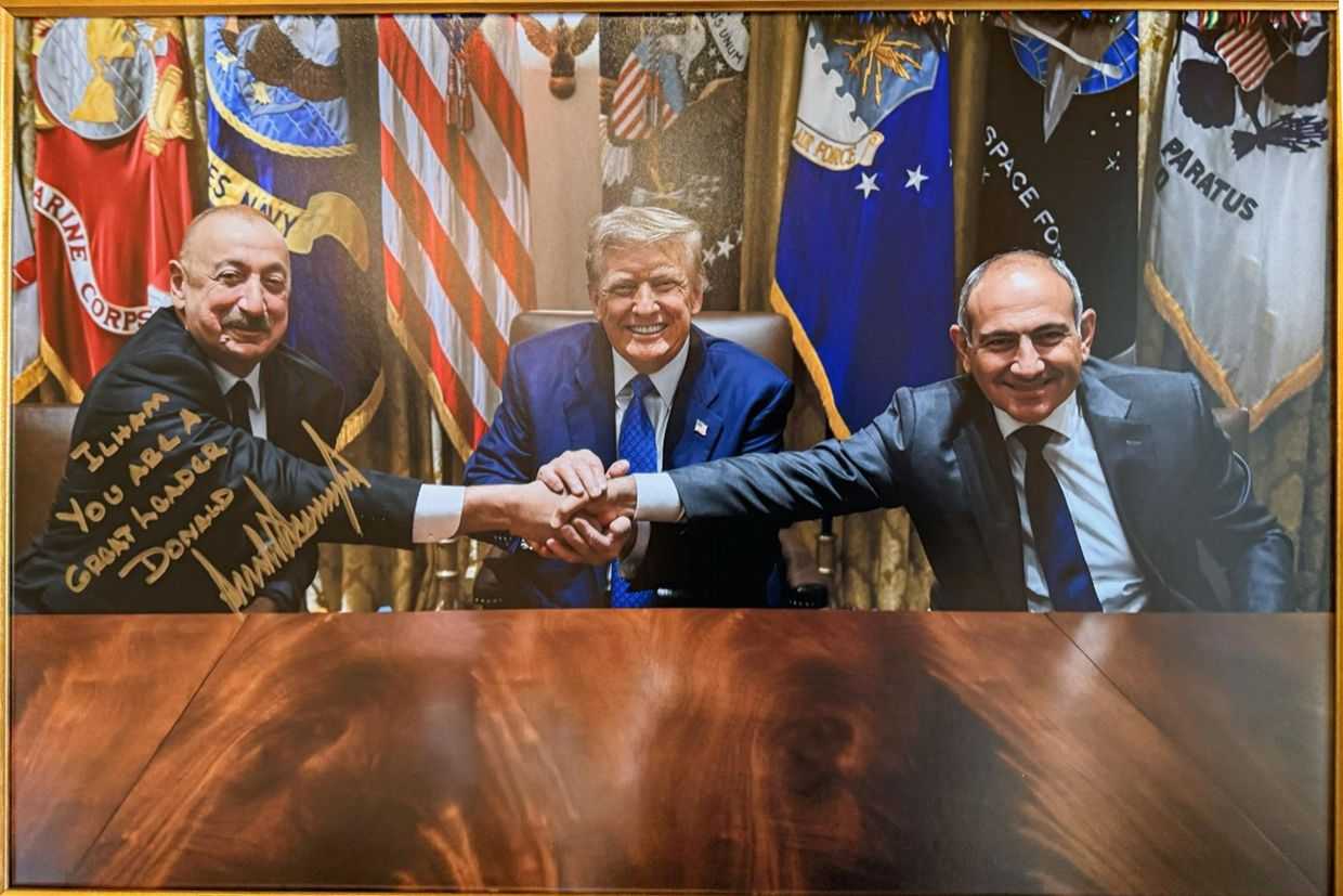 A signed photo gifted by US President Donald Trump (center) of a trilateral meeting with Trump, Azerbaijani President Ilham Aliyev (left), and Armenian Prime Minister Nikol Pashinyan (right). Photo: Ilham Aliyev/X.