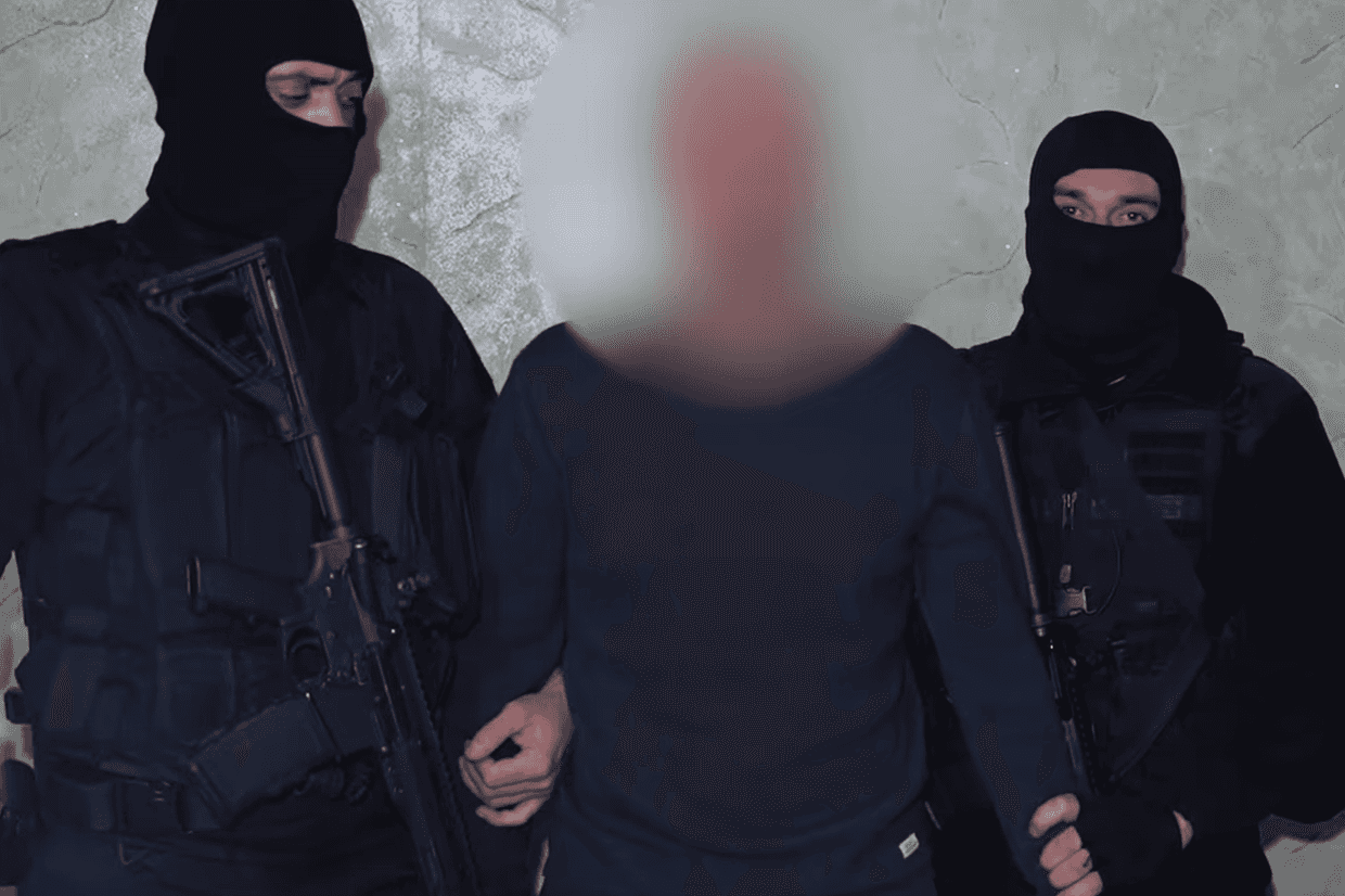 Police detain a man allegedly involved with the ‘criminal underworld’. Screengrab from video.