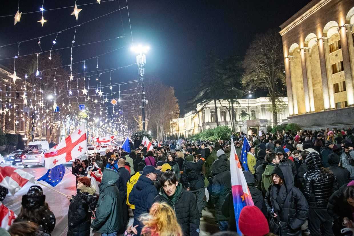Anti-government demonstrators standing on the pavement near parliament. Photo: Mariam Nikuradze/OC Media.