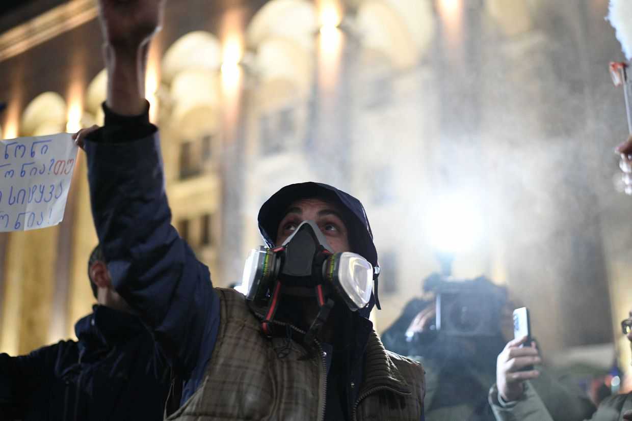 Protesters staging a performance in front of parliament on the night of 1 December. Photo: Mariam Nikuradze/OC Media.