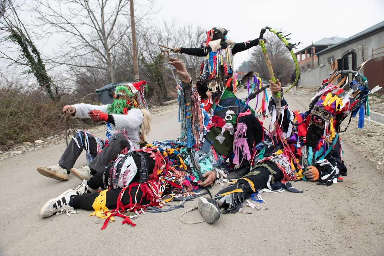 Masked characters known as Berikas roll screaming in the middle of a road, blocking passing cars. Photo: Tamuna Chkareuli/OC Media.