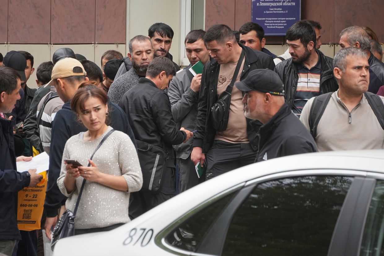 Migrants queue to enter a centre for government services in St. Petersburg, Russia, in August 2025. Photo: AP/Dmitry Lovetsky.