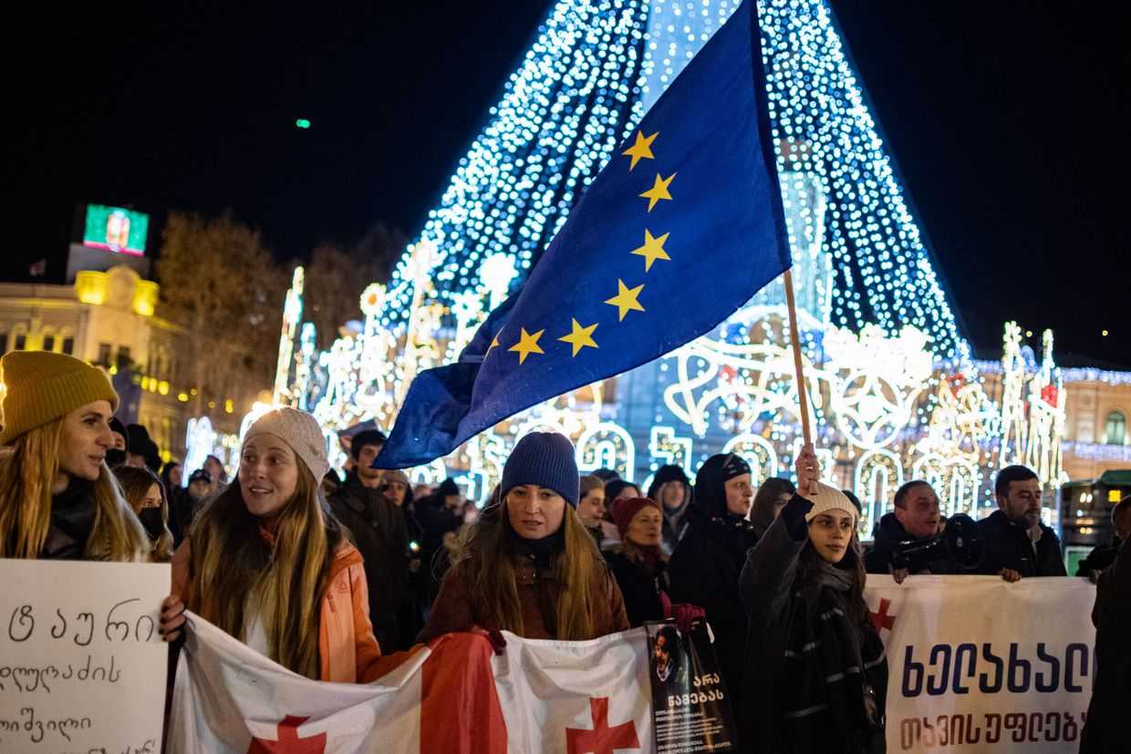 Protesters carry EU and Georgian flags at a protest in Tbilisi on 19 December 2024. Photo: Mariam Nikuradze/OC Media.