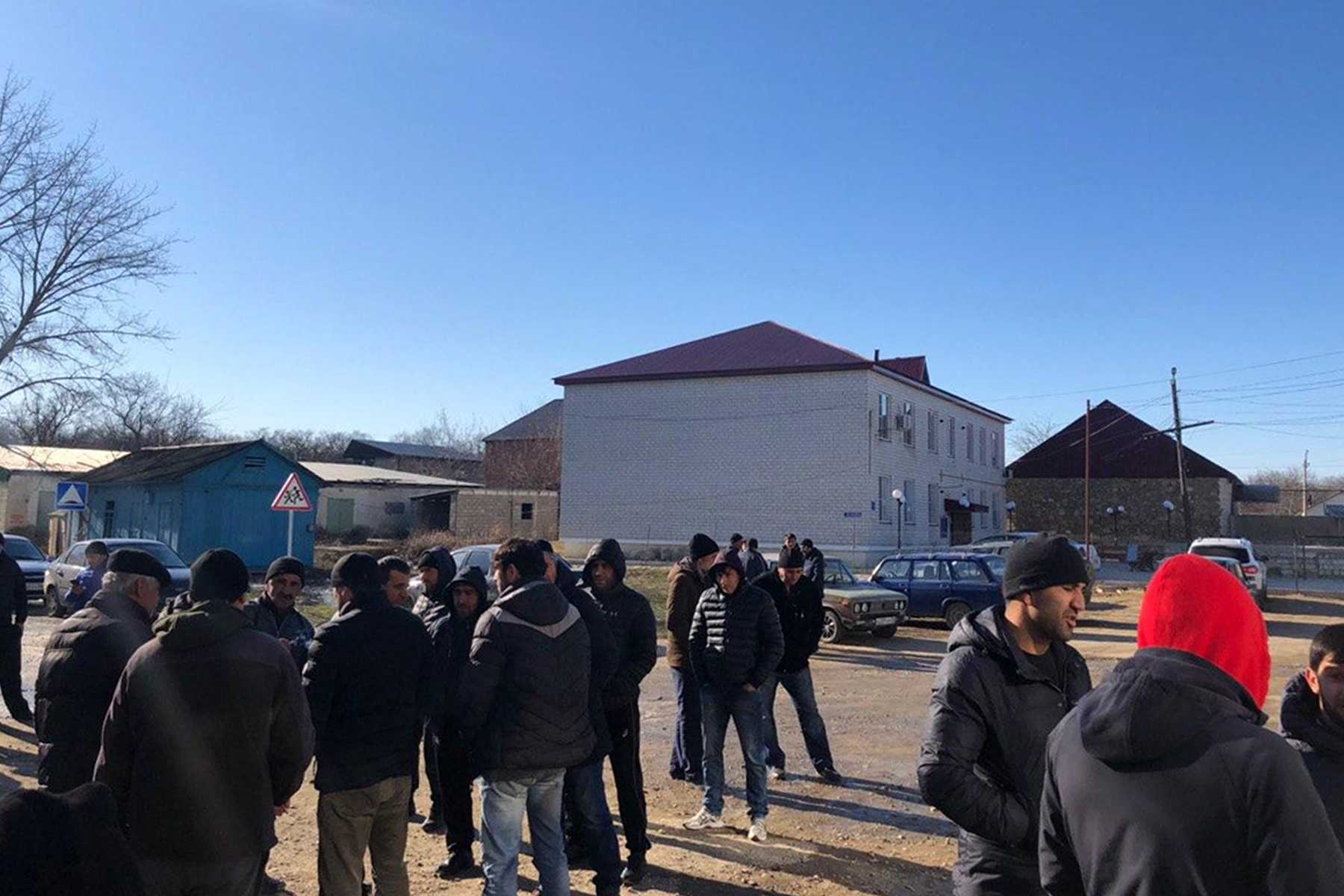 Local residents gather at the Novokayakent village square. 