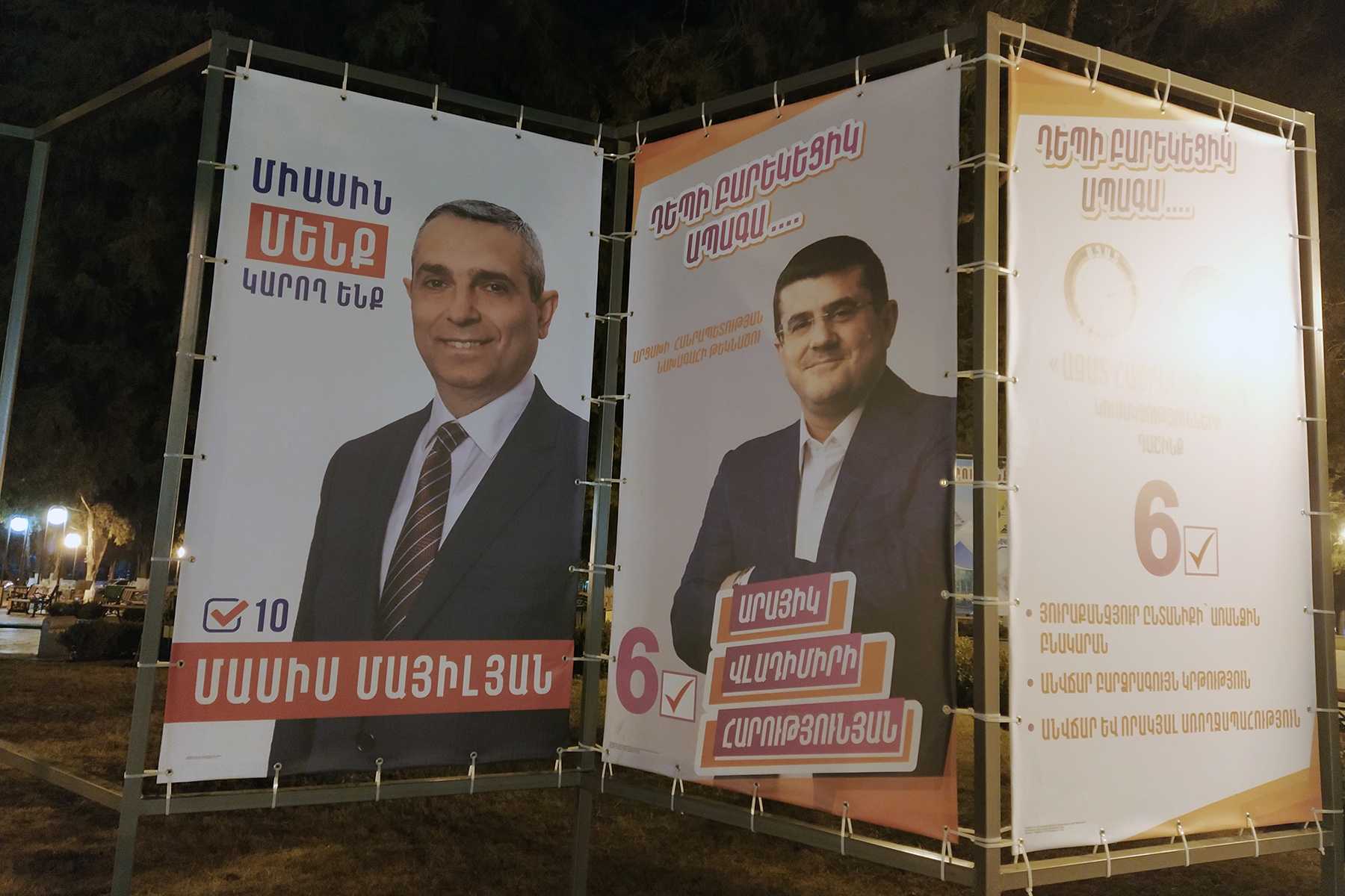 A campaign poster for Masis Mayilyan (left), with his slogan ‘Together we can’, and Arayik Harutyunyan (centre) with the slogan ‘Towards a prosperous future’. Photo: Mariam Sargsyan/OC Media.