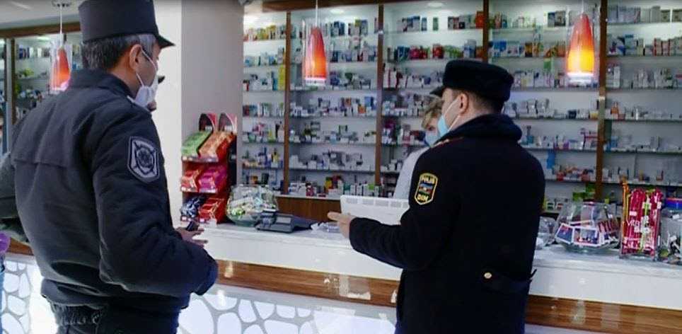 Police officers checking a pharmacy in Ganja. Photo: Trend.
