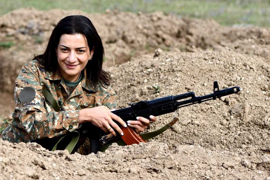 Anna Hakobyan holding an assault rifle.  Official photo. 