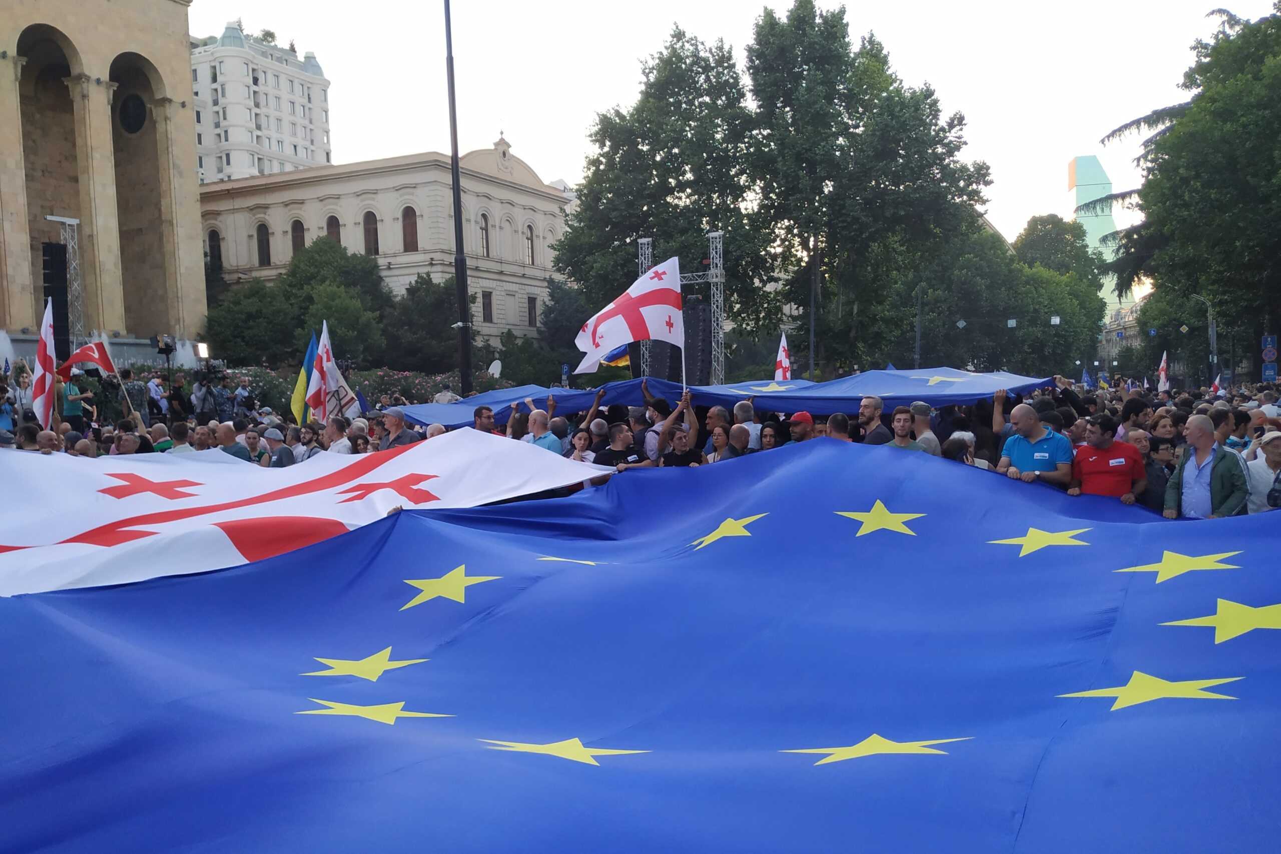 A giant EU flag alongside the Georgian flag at the demonstration outside parliament on 3 July 2022. Photo: Shota Kincha/OC Media.