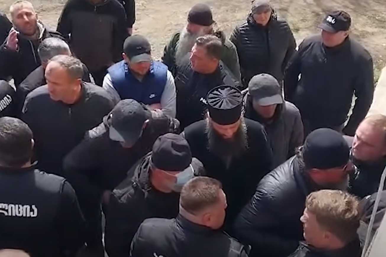 A mob led by Orthodox priests attempting to break into Imam Merab Mikeladze’s home to disrupt his prayer.