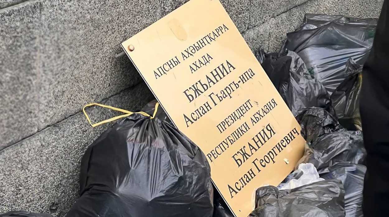 President Aslan Bzhaniya's office nameplate in the trash after protesters stormed the parliament. Image via social media.