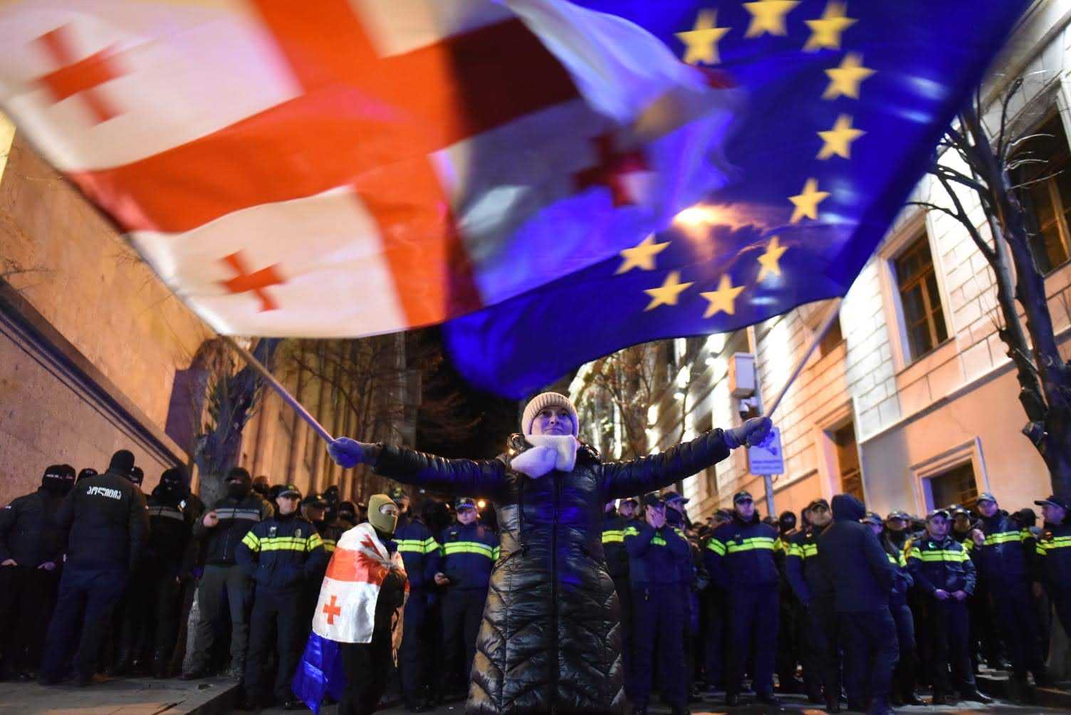 Protester waving Georgian and EU flats near the parliament on 24 November night. Image: Mariam Nikuradze/OC Media.