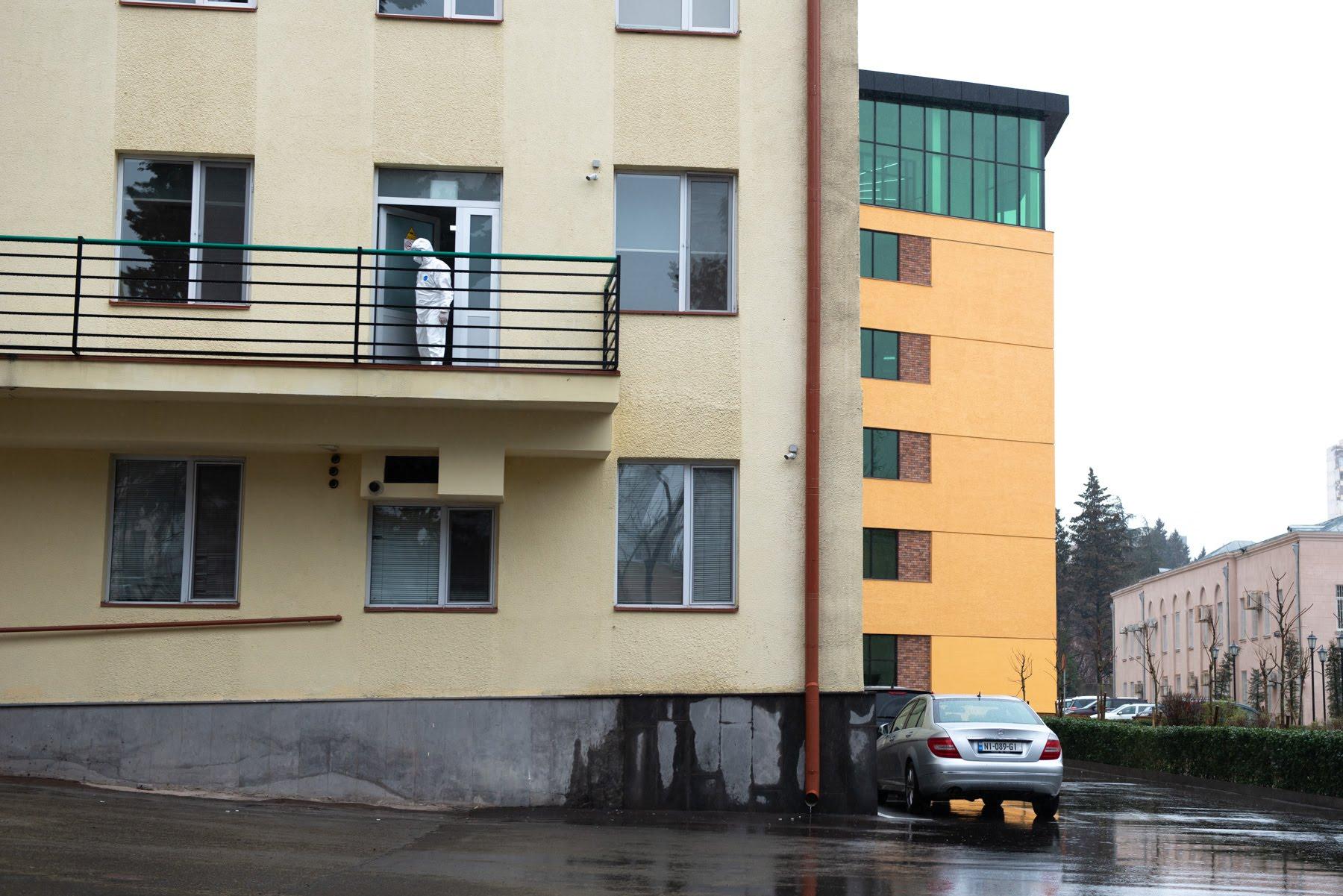 A health worker on a hospital balcony in Tbilisi. Photo: Tamuna Chkareuli/OC Media.