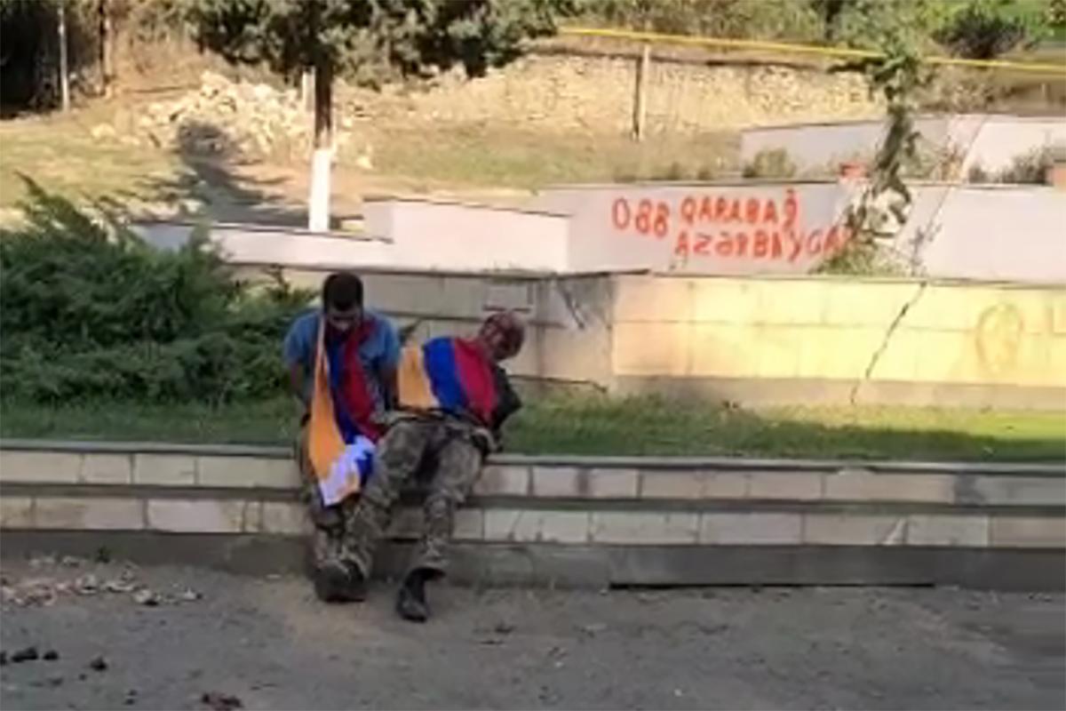 A still from a video appearing to show two Armenian captives shortly before they are shot dead.