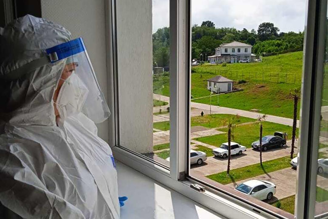 A medical worker looks out of a window at the Gudauta COVID-19 Centre. Photo: Gugutsa Vardania.