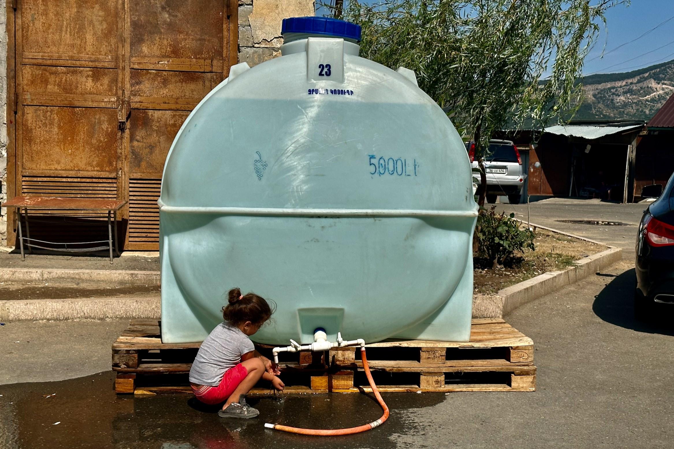 A child washing their hands at a water station in Stepanakert. Photo: Marut Vanyan/OC Media