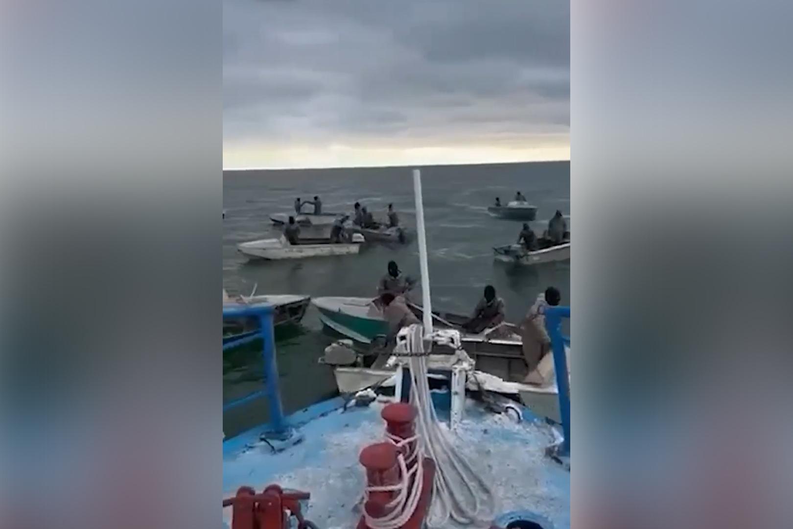 A screengrab from footage showing fishing boats gathering around a patrol boat in Lake Sevan. Screengrab via Youtube.