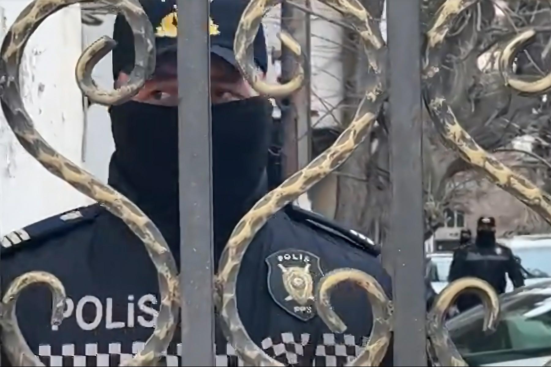 Police outside the office of Toplum TV in Baku. Screengrab from video by RFE/RL