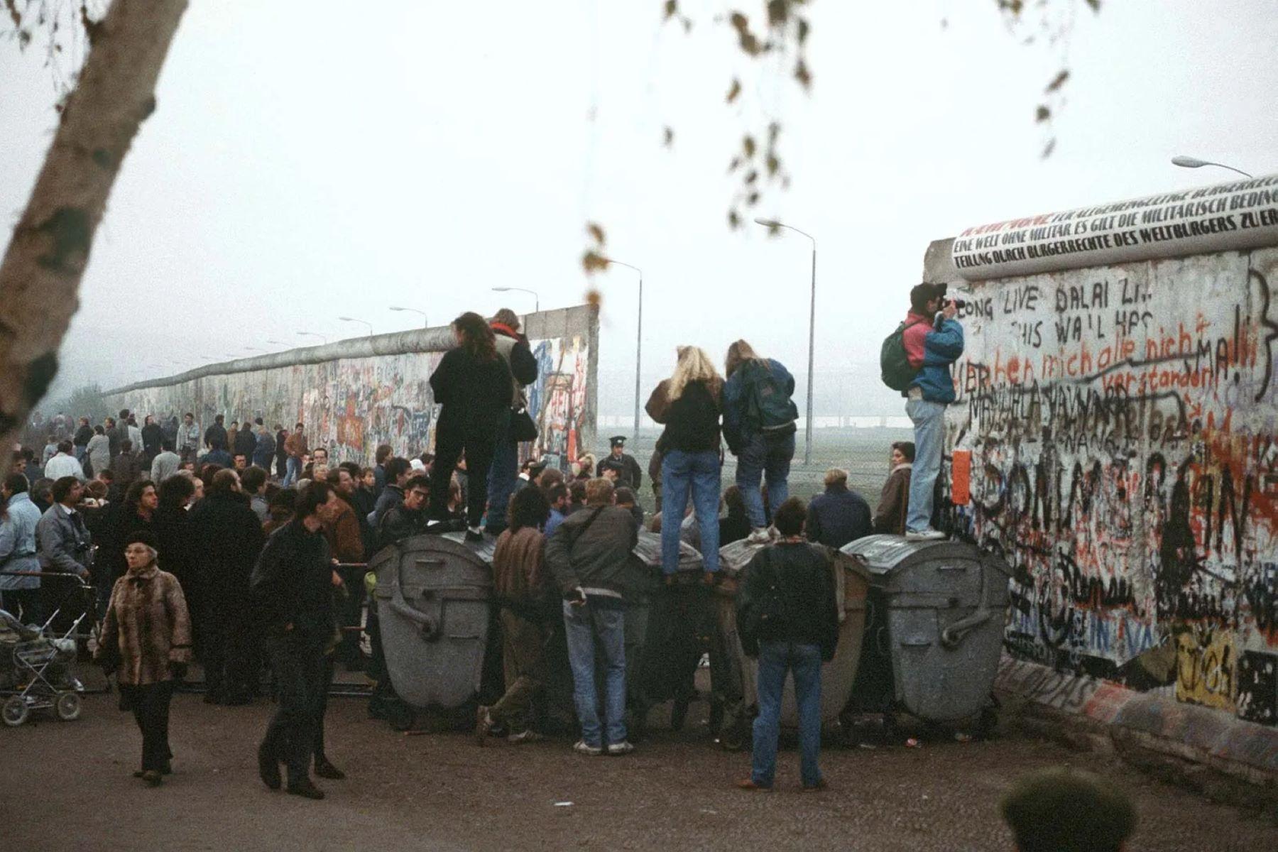 West German citizens gathering at a newly created opening in the Berlin Wall at Potsdamer Platz in November 1989. Image via Britannica.