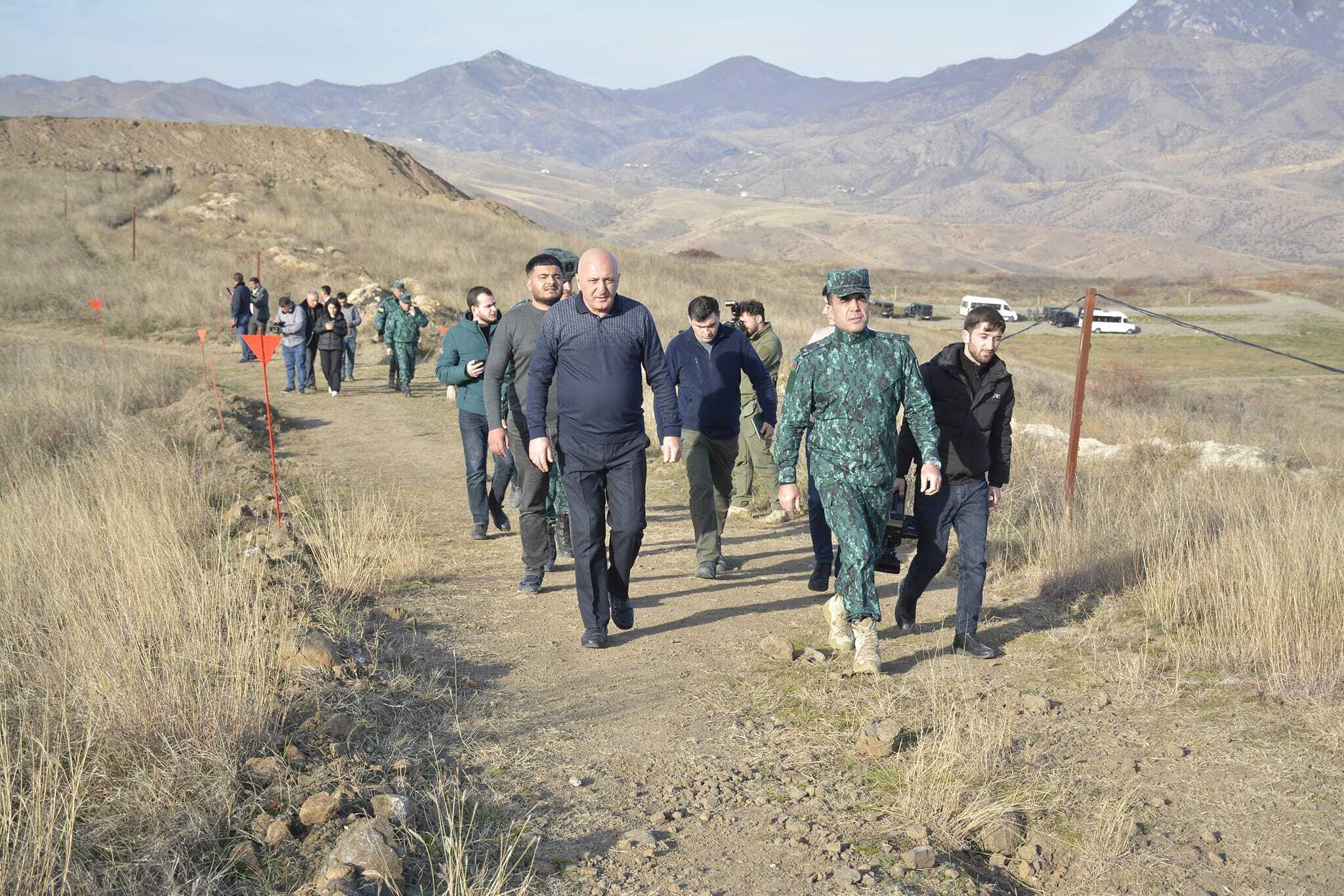 Adalat Verdiyev (left) pictured during the military tour of border villages he was accused of sharing state secrets from. Image via social media.