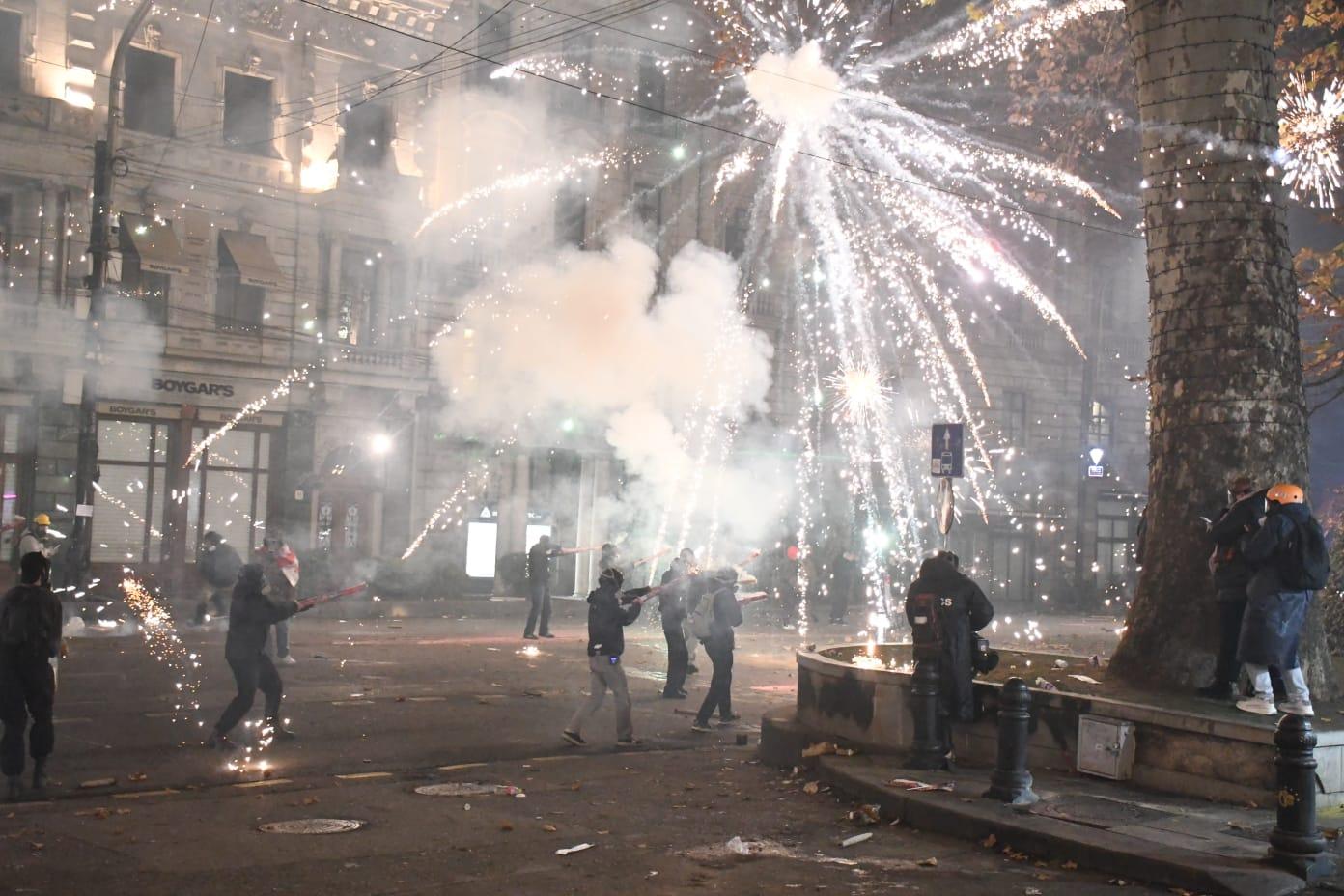 Protesters launch fireworks at advancing riot police in Tbilisi in the early hours of 4 December. Photo: Mariam Nikuradze/OC Media.