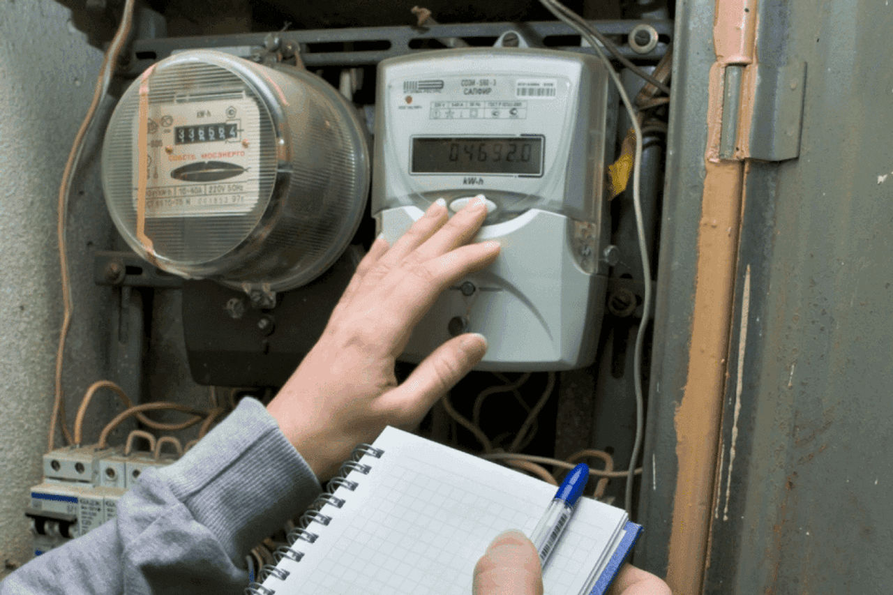 A meter reader records electricity usage. Official image. 