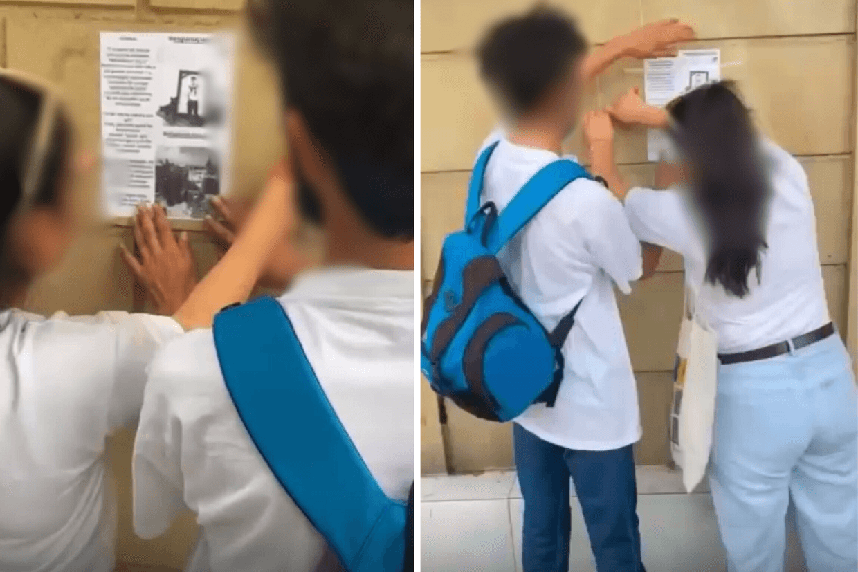 Teenagers stick pamphlets to walls in the Gazakh district. Screenshot from a video shared via social media.