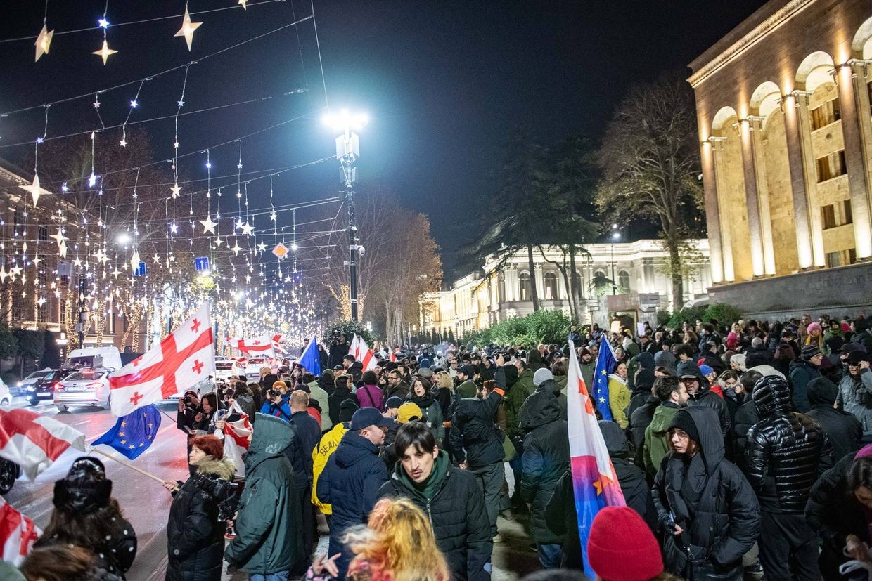 Anti-government demonstrators standing on the pavement near parliament. Photo: Mariam Nikuradze/OC Media.