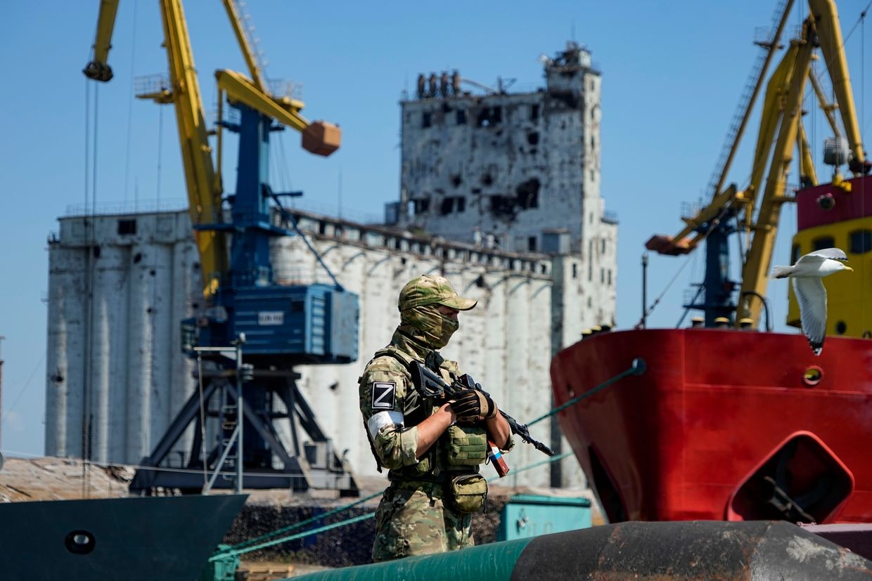 A Russian soldier guards a pier in the Russian-occupied Ukrainian port city of Mariupol in June 2022. Photo: AP.&nbsp;