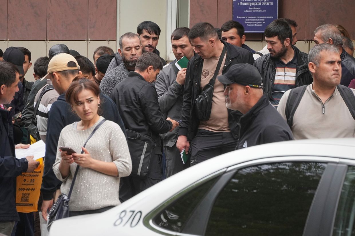 Migrants queue to enter a centre for government services in St. Petersburg, Russia, in August 2025. Photo: AP/Dmitry Lovetsky.