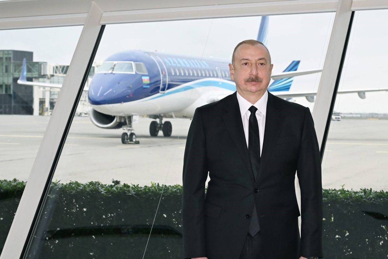 Azerbaijani President Ilham Aliyev stands in front of an Azerbaijan Airlines plane at Baku's Heydar Aliyev Airport. Official image.