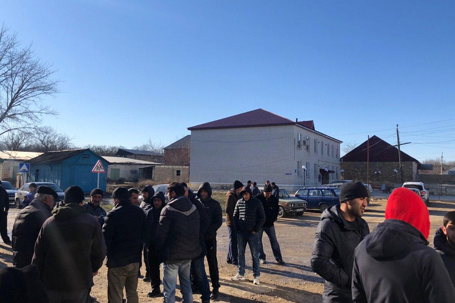 Local residents gather at the Novokayakent village square. 