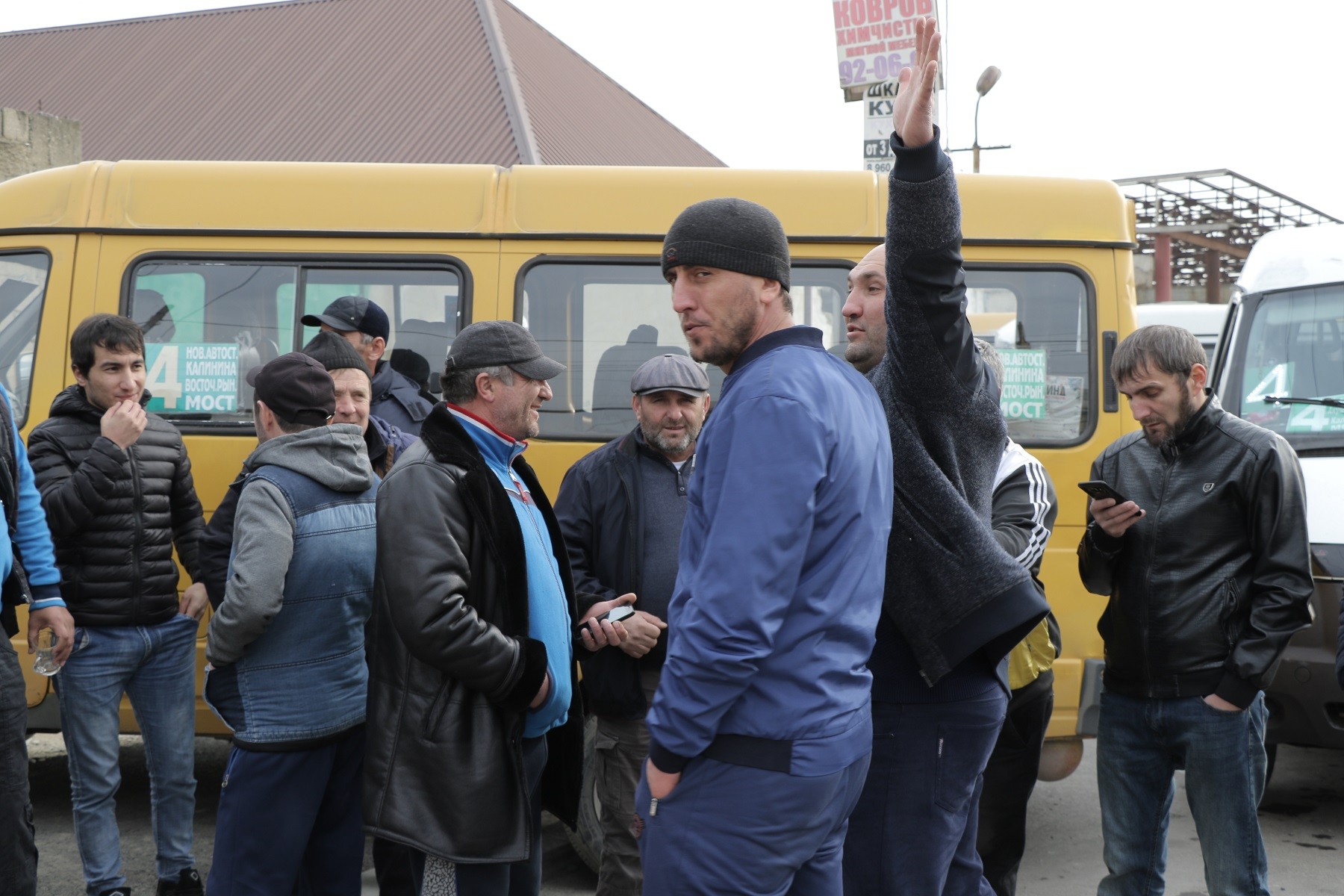 Striking workers in front of a minibus. Photo by Ilya Ilyasov.