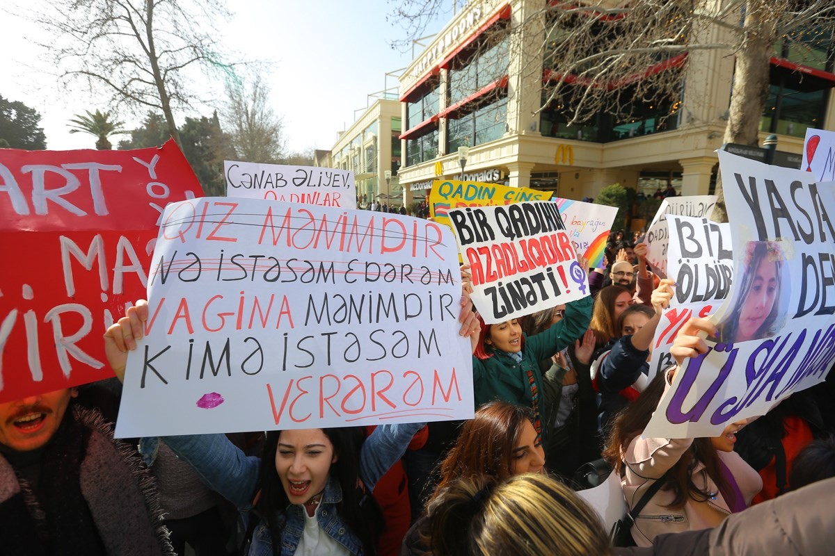 Aysel Alakberzade holding a poster on the International Women’s Day rally in Baku with ‘The girl is mine. I can do whatever I want with her’ crossed out followed by ‘My vagina is mine. I can give it to whomever I want’. Photo: RFE/RL.