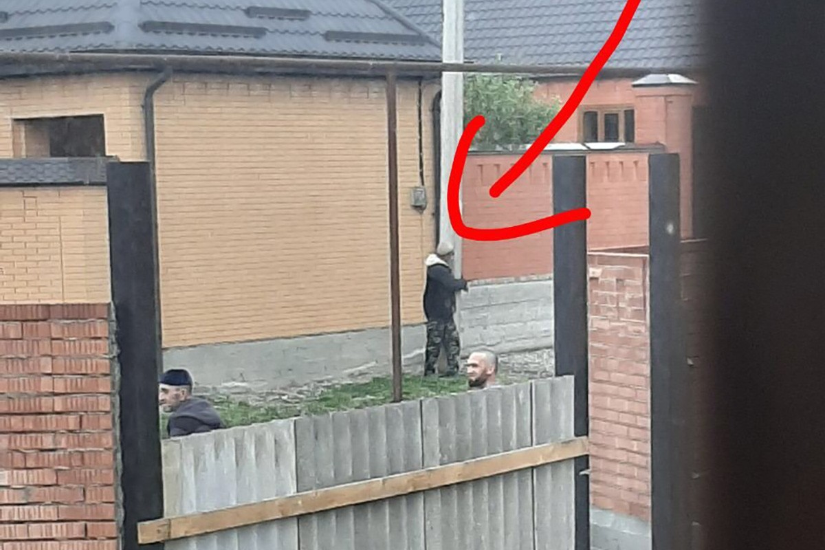 A photo disseminated online of a man allegedly tied to poll for leaving his home.