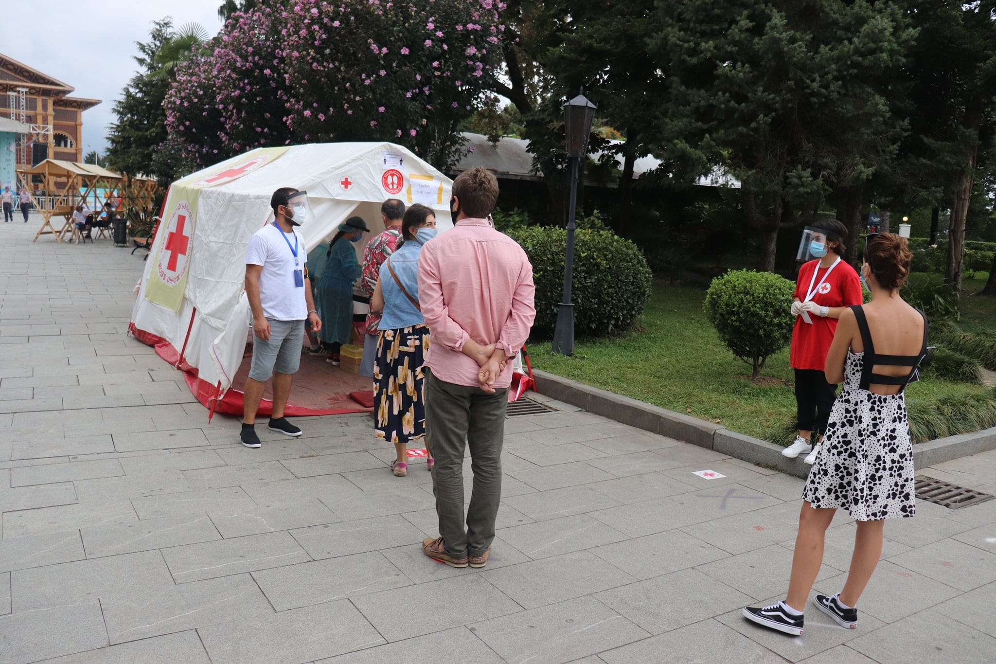 People stand in line for free testing in a tent on Batumi Boulevard, one of several such locations organised after a recent spike in numbers in the region. Photo: NCDC.