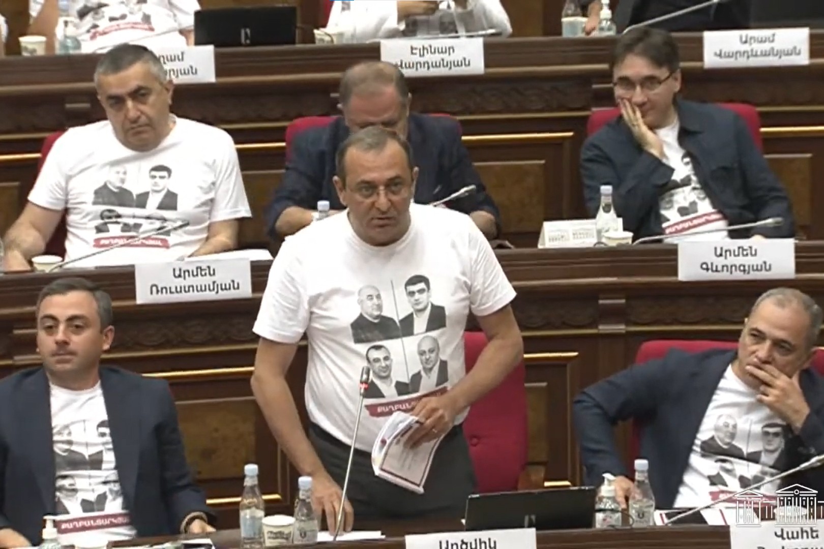 MPs from the Armenia Alliance wearing T-shirts printed with the faces of arrested supporters. Image via parliament.am.