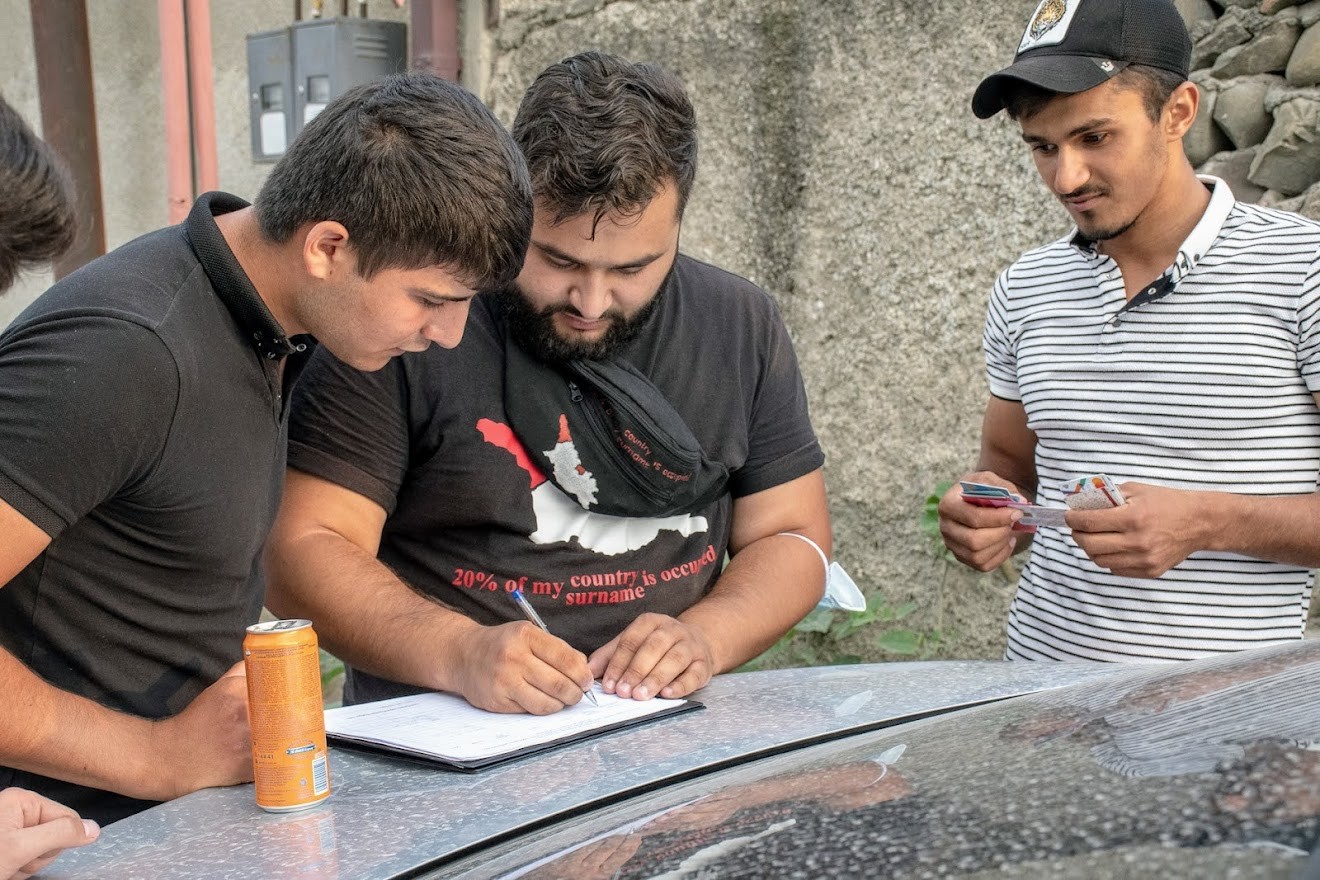 Caption: Rabil Ismail, Salam campaigner, collecting signatures in Karajala, the village in Georgia’s Kakheti region. Image: Shota Kincha/OC Media.