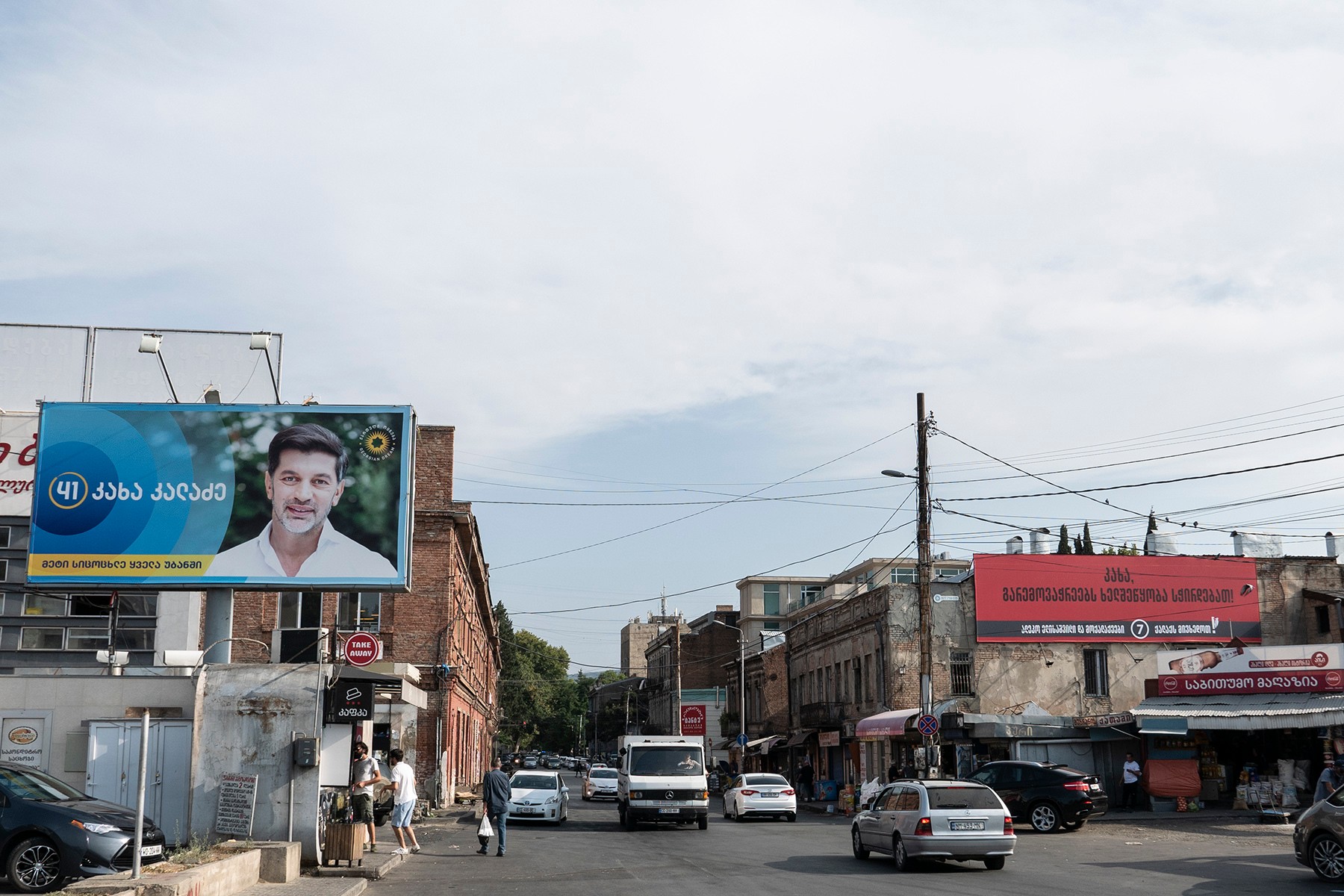 An election poster for Georgian Dream's Kakha Kaladze alongside a poster for Aleko Elisashvili’s Citizen’s Party. Photo: Mariam Nikuradze/OC Media. 