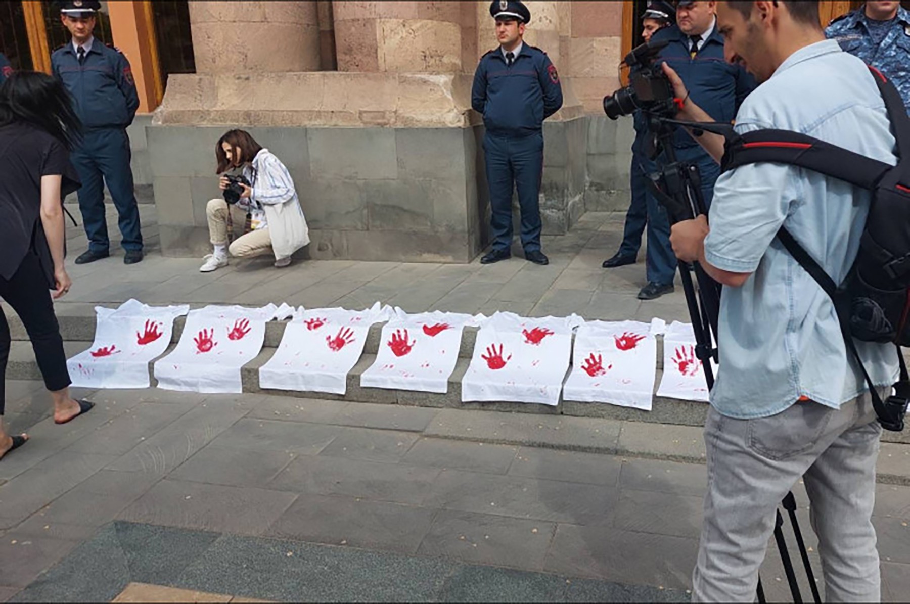 Protestors with signs showing 'bloody hands' in front of the government building in Yerevan. Photo via Tert.am.