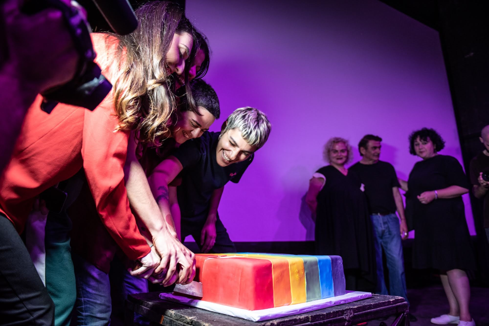 Activists slice a rainbow cake at the film screening. Photo: Mariam Nikuradze/OC Media.