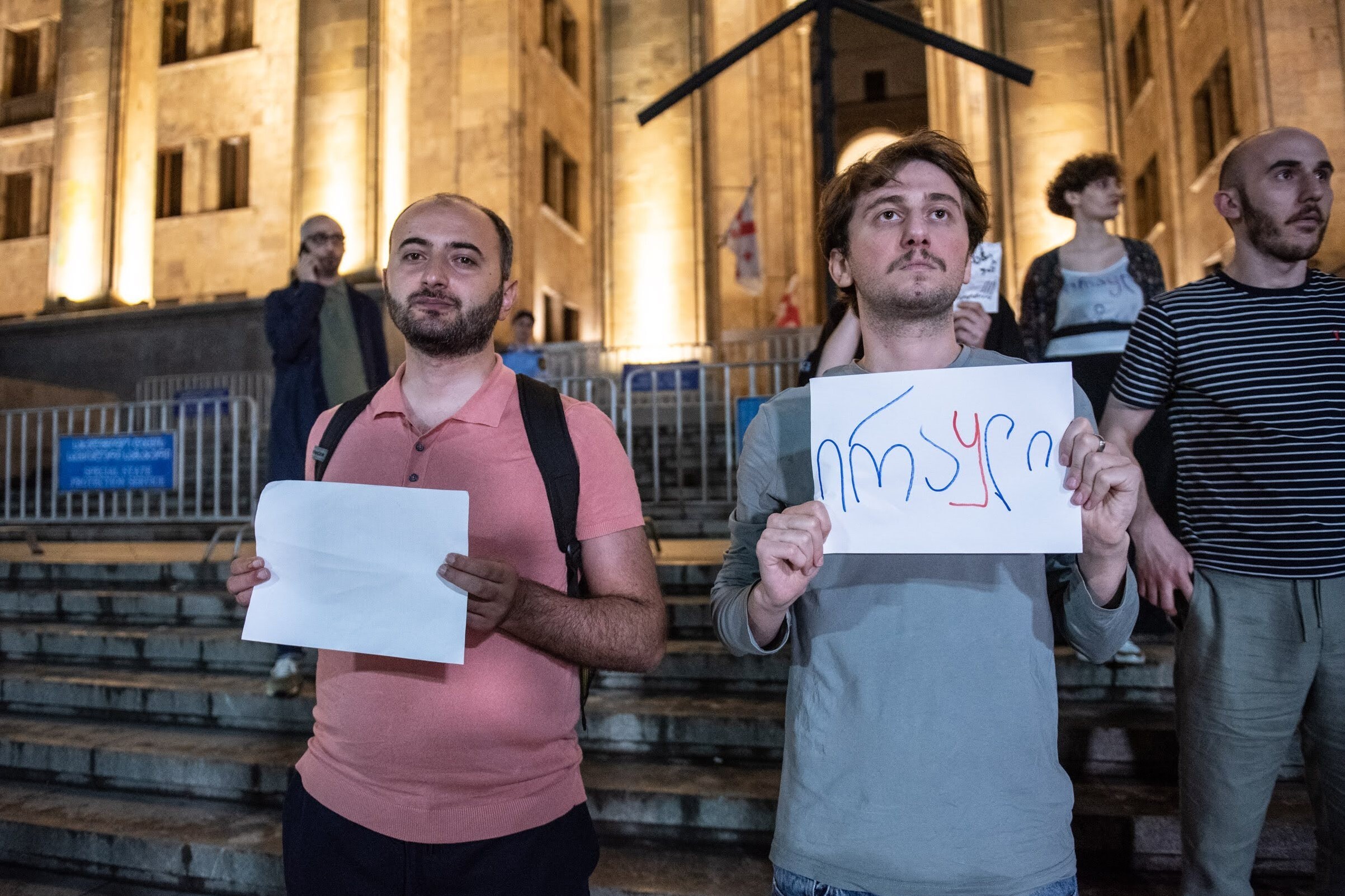 Eduard Marikashvili (left) holding a blank sheet of paper at a protest on 2 June. Photo: Mariam Nikuradze/OC Media.