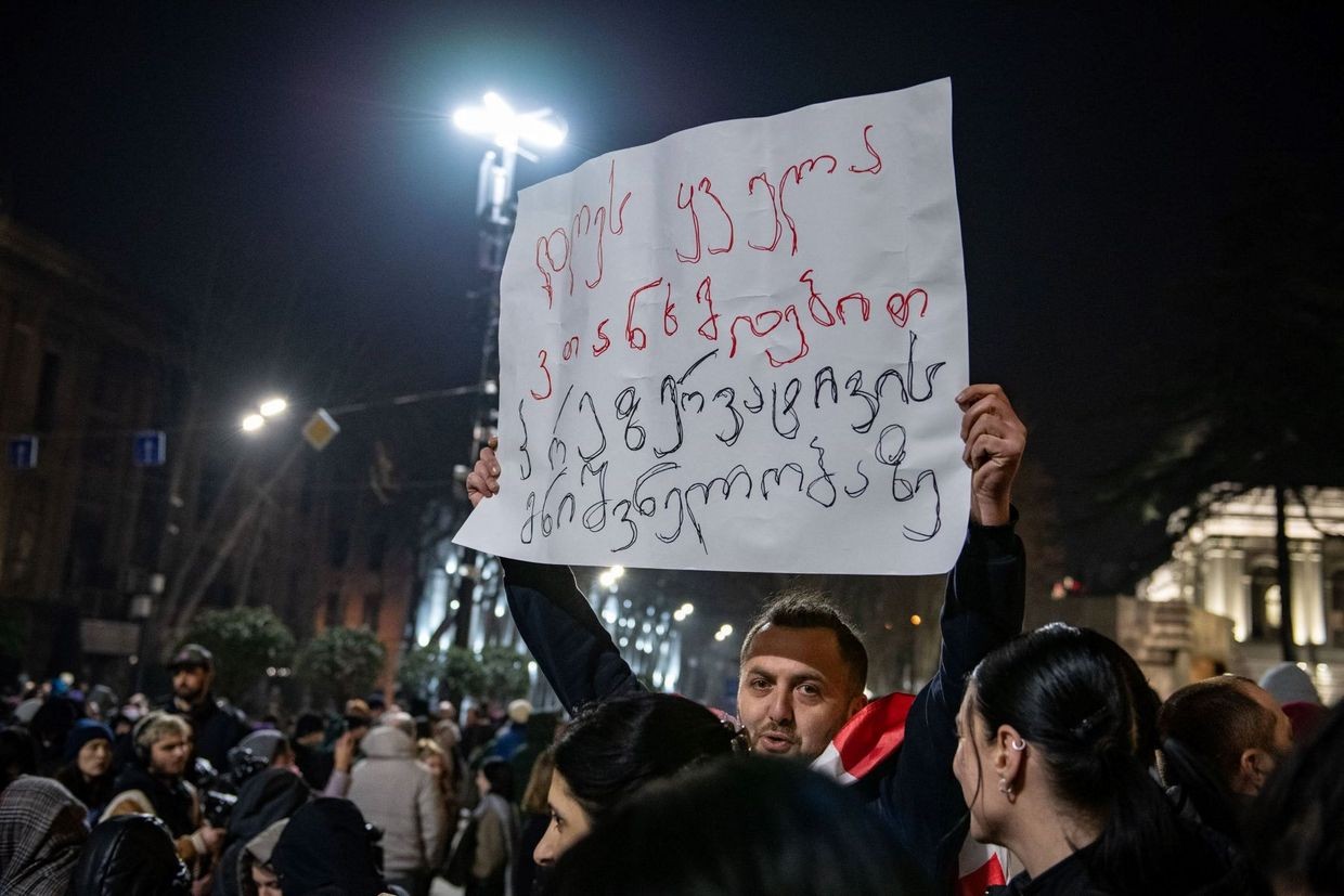 Lasha Jioshvili holds a banner saying: ‘Today, we all agree on the importance of condoms’. Photo: Mariam Nikuradze/OC Media.