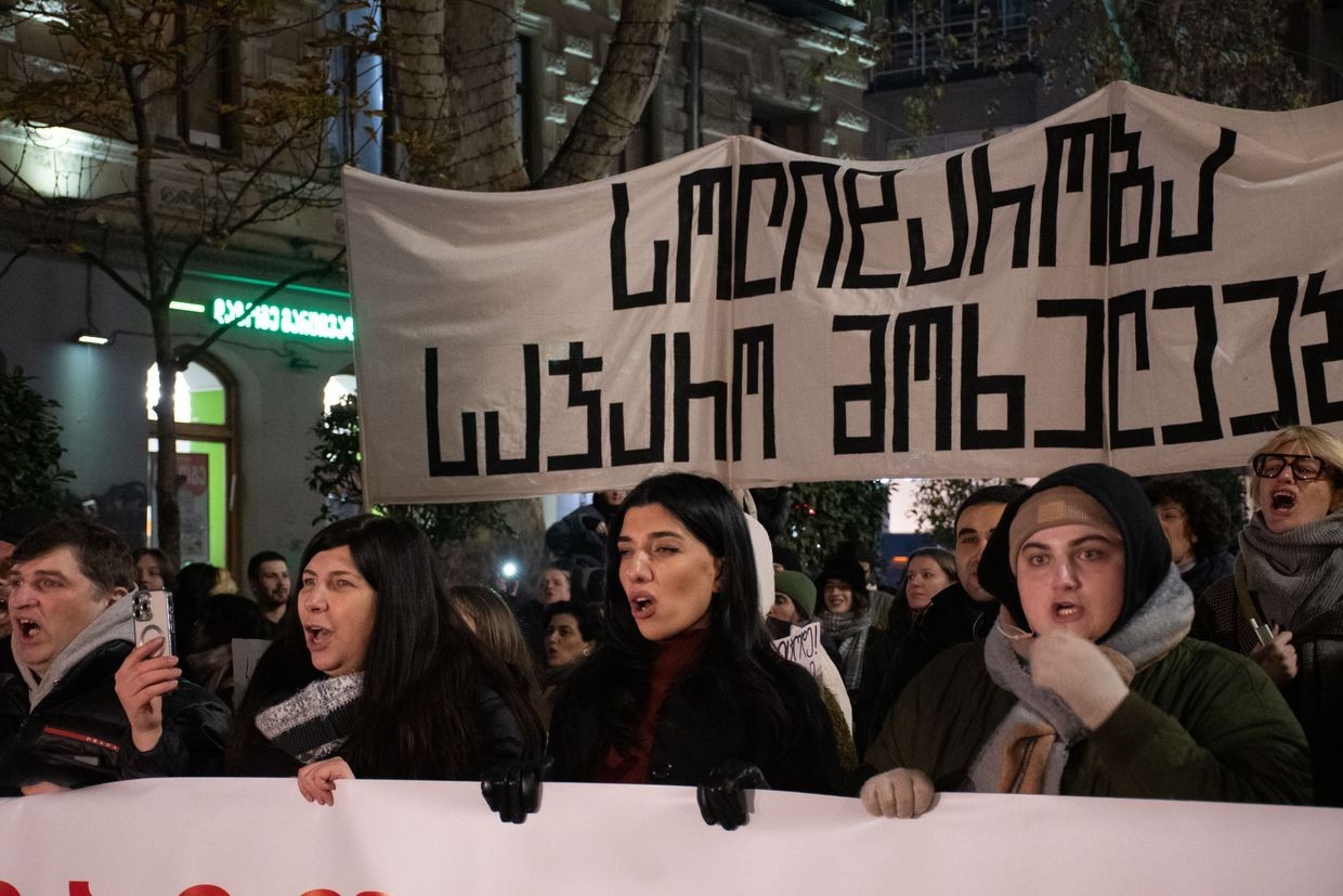 A group of dismissed parliamentary employees march in Tbilisi holding a banner which reads ‘solidarity to civil servants. Photo: Mariam Nikuradze/OC Media.