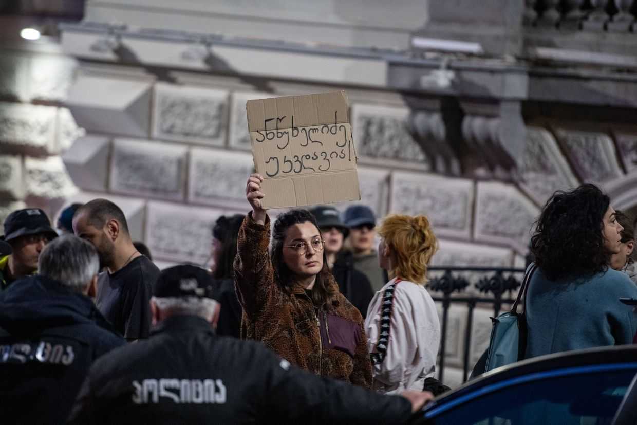 A protester holds a handwritten sign reading ‘Antsukhelidze is immortal’ during a protest on 28 March. Photo: Mariam Nikuradze/OC Media.