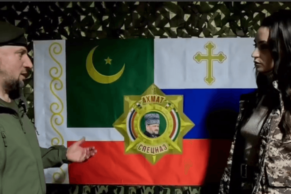Chechen Akhmat commander Apti Alaudinov sharing the unit's new flag. Screengrab from video by Anastasiya Babir.