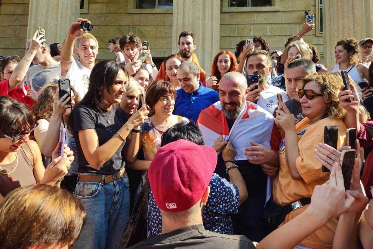 Giorgi Akhobadze greets supporters as he leaves the court free on 6 August. Photo: Levan Zazadze.
